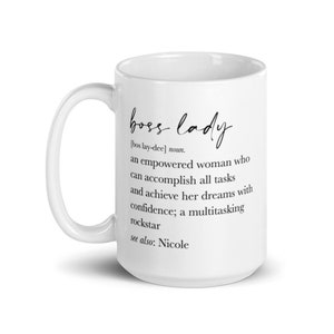 May include: White ceramic mug featuring the words "boss lady" in elegant script. The mug includes a definition of "boss lady" and the text "see also: Nicole". A great gift for an empowered woman.