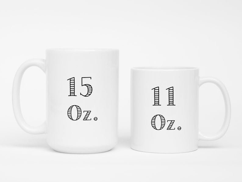 May include: Two white ceramic mugs. The larger mug has "15 Oz." printed in black, and the smaller mug has "11 Oz." printed in black. Both mugs have a simple, clean design.
