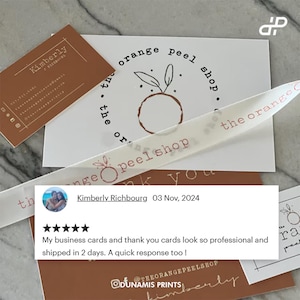 High-quality glossy business cards with UV coating, thick 14pt cardstock, durable finish.