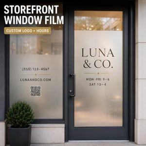 May include: Frosted storefront window film applied to a glass door and adjacent window. The design features the text LUNA & CO., business hours, a phone number, a website URL, and a QR code in dark lettering with gold accent lines and stars.