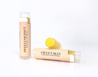 May include: Two lip balm tubes, one labeled "Sweet Coconut Natural Lip Balm" and the other labeled "Sweet Skin Normalizing Luxury Skincare".