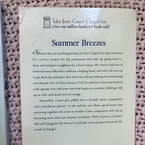 May include: A book cover with the title "Summer Breezes" from the "Tales from Grace Chapel Inn" series. The cover features text about the story's plot, including a summer challenge and romance.