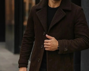 May include: A brown suede coat with a shearling collar and lining. The coat has a button-up front and buttoned cuffs. The coat is a dark brown color.