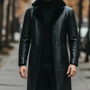 May include: A long, black leather coat with a fur-lined collar. The coat has a button-up front and a tailored fit. The person in the image is wearing a black turtleneck sweater underneath. The coat appears to be made of high-quality leather.