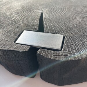 May include: A dark gray wooden serving tray with a natural wood grain pattern. The tray has a rectangular metal insert in the center.
