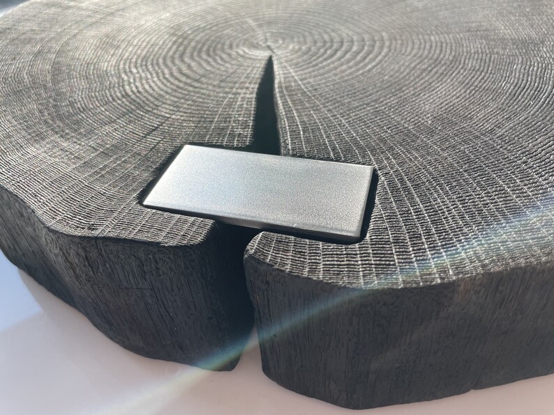 May include: A dark gray wooden serving tray with a natural wood grain pattern. The tray has a rectangular metal insert in the center.