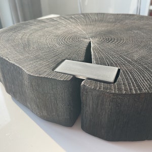 May include: A large, dark gray wooden serving tray with a natural wood grain pattern. The tray has a metal insert in the center.
