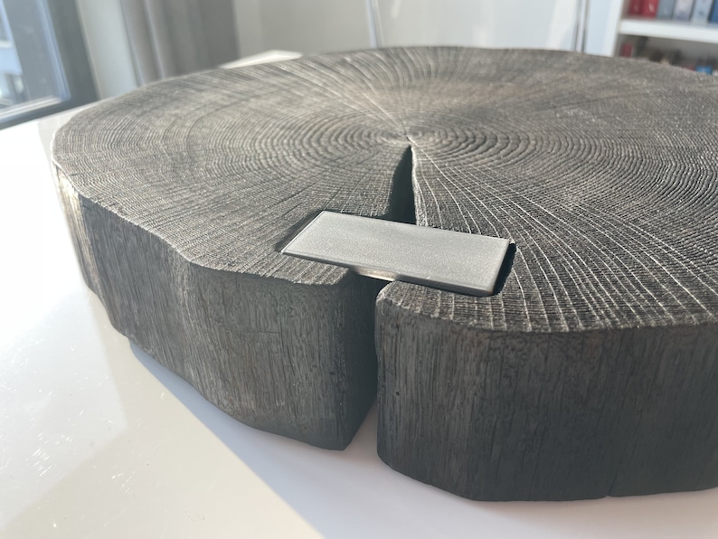 May include: A large, dark gray wooden serving tray with a natural wood grain pattern. The tray has a metal insert in the center.