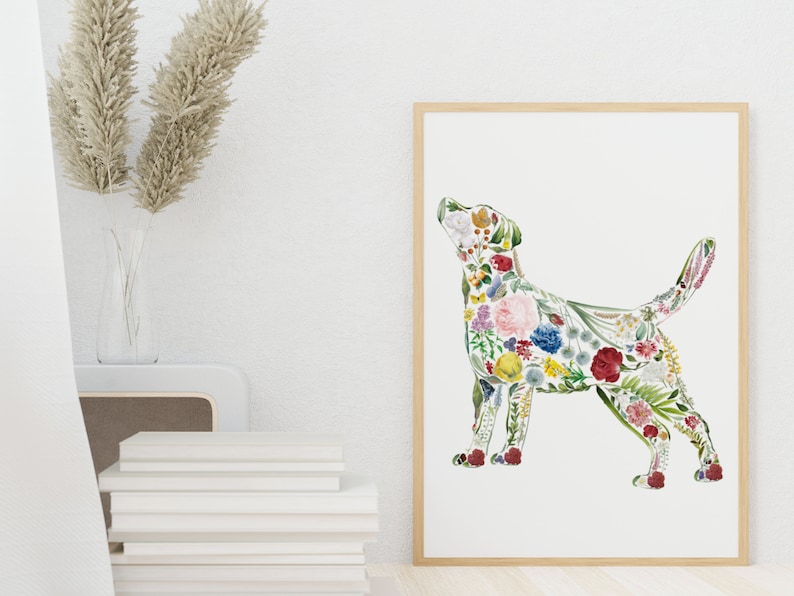 May include: A framed art print featuring a dog silhouette filled with colorful flowers. The artwork has a white background and a natural wood frame. The flowers include red, pink, yellow, and blue blooms, creating a vibrant and artistic design.