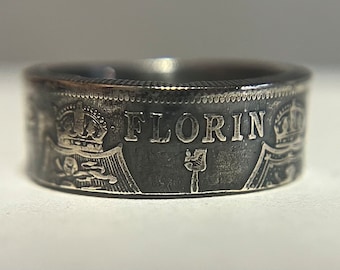 May include: A silver ring made from a repurposed British Florin coin. The ring features the inscription "FLORIN" and a crown on each side.