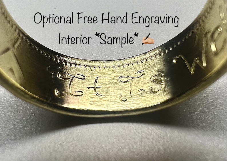 K&ouml;nnte beinhalten: Ein goldfarbener Ring mit einer glatten Innenseite, in die die kursiven Buchstaben T und S von Hand eingraviert sind. &Uuml;ber dem Ring steht der Text Optional Free Hand Engraving Interior Sample sowie ein kleines Symbol einer Hand mit Stift.