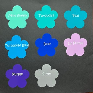 May include: Nine flower-shaped stickers in various colors, including mint green, turquoise, teal, turquoise blue, blue, light purple, purple, and silver. The stickers have the color names written on them.