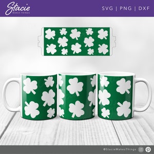 May include: Three white mugs with green shamrock patterns. The mugs are on a wooden surface. The text "Stacie Makes Things" is at the top of the image.