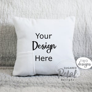 May include: White pillow with a pocket on the front. The pillow has the text "Your Design Here" printed on the front. The pillow is sitting on a grey and white textured surface.
