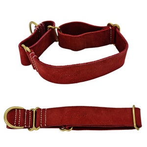 May include: Two red leather dog collars with brass hardware. The top collar is a martingale style with a wider strap and the bottom collar is a flat strap style. Both collars have white stitching and the text "Pawsitive" embossed on the leather.