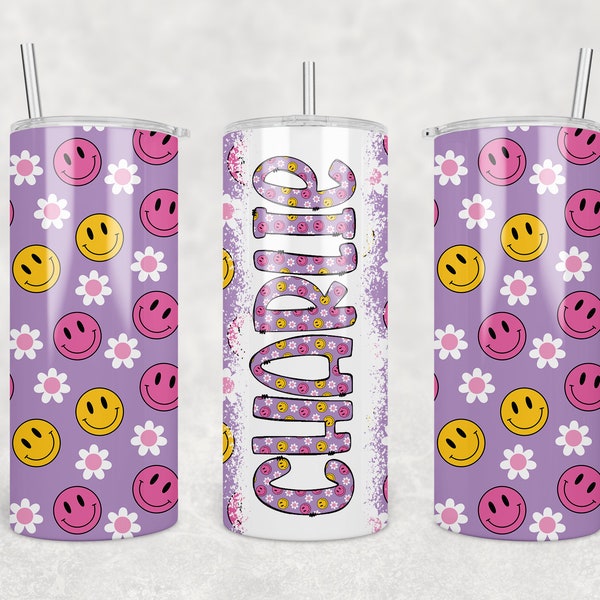 May include: A purple stainless steel tumbler with a white background and a pattern of yellow smiley faces and pink flowers. The tumbler is 15oz and has a straw. The text "Charlie" is written on the tumbler in a white, distressed font.