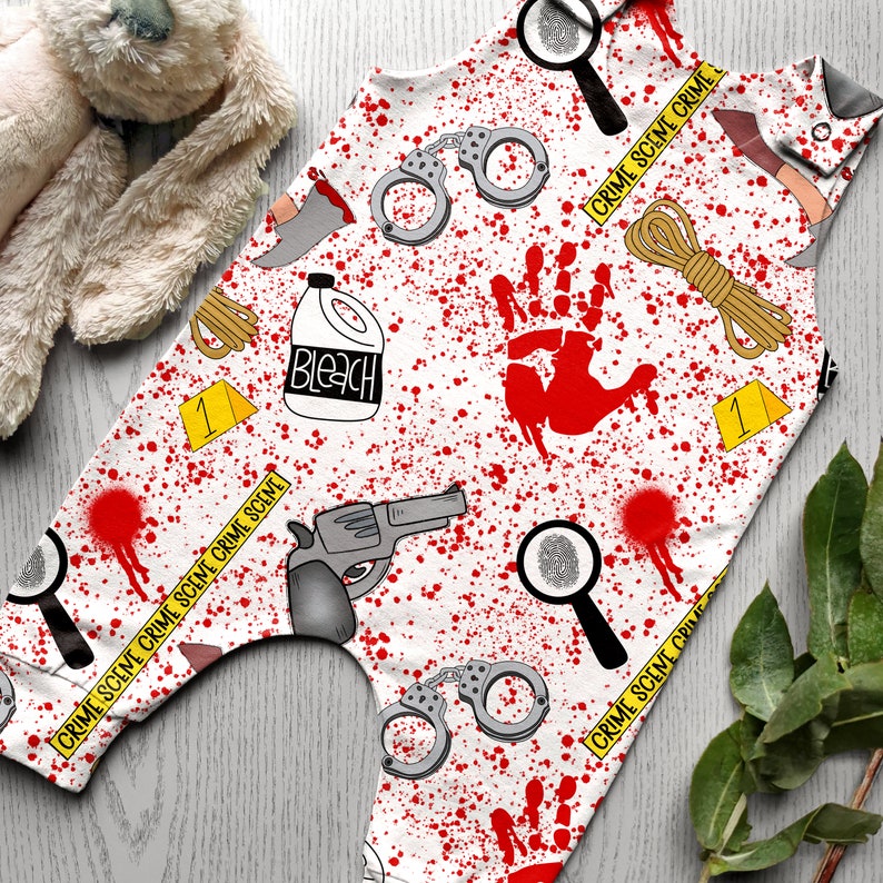 K&ouml;nnte beinhalten: Ein wei&szlig;er Baby-Strampler mit einem rot-wei&szlig;-schwarzen Tatort-Muster. Der Strampler zeigt verschiedene Tatort-Elemente, darunter Handschellen, eine Lupe, eine Flasche Bleichmittel, ein Seil und einen blutigen Handabdruck. Der Text "CRIME SCENE CRIME SCENE CRIME SCENE" wird um den Strampler herum wiederholt.