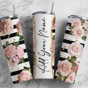May include: Three stainless steel tumblers with a black and white striped background and pink floral designs. The centre tumbler has the text "Add Your Name" in black.