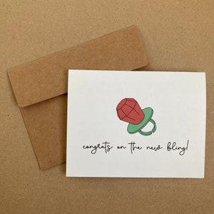 Félicitations pour ce nouveau bijou ! - une carte de fiançailles - des félicitations - une bague - un bonbon