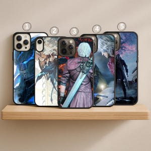 May include: Five black phone cases with different character designs. The cases feature images of characters from a video game. The cases are displayed on a light brown wooden shelf.