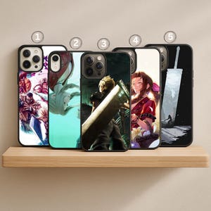 May include: Five black phone cases with colorful Final Fantasy artwork. The cases feature various characters and scenes from the game, including Cloud Strife with his Buster Sword. The cases are displayed on a wooden shelf.