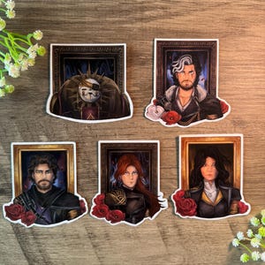 May include: Five stickers showcasing portraits within decorative frames. Each portrait presents a person with distinct characteristics, adorned with red roses. The portraits have a fantasy theme, with detailed artwork and vibrant colours.