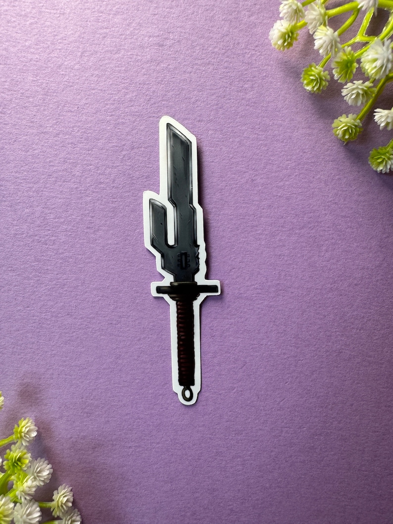 May include: A silver-coloured sword with a black handle and a decorative design on the blade. The sword is on a purple background.