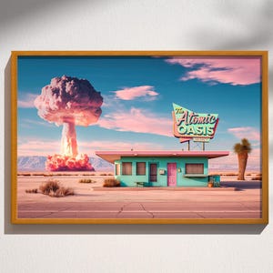 May include: A framed print of a retro motel scene, "The Atomic Oasis," with a mushroom cloud in the background. The motel is teal with a pink roof and sign. The sky is blue and pink, and the landscape is desert-like.