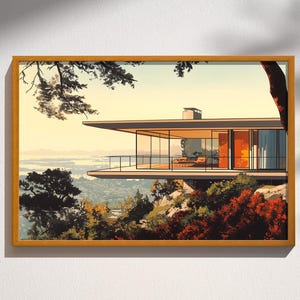 May include: A framed print depicting a modern house with a flat roof and glass walls. The house is situated on a hillside, overlooking a landscape of trees and water. The colour scheme features shades of orange, brown, and green.