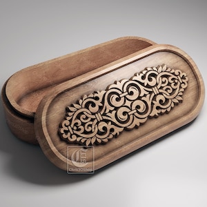 May include: An open, oval wooden box with a detailed carved floral pattern on the lid. The box is crafted from light brown wood. The lid is partially open, revealing the interior.