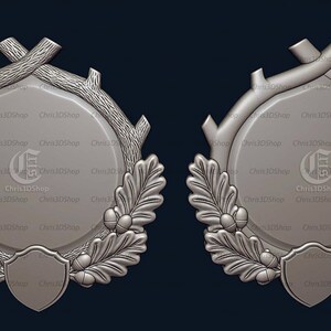 May include: Two silver-coloured, ornate, circular frames with a raised, textured design. Each frame features a central circle with a raised, textured border, surrounded by a wreath of oak leaves and acorns. The frames are decorated with a stylised letter "G" in the centre.