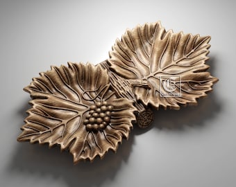 May include: A decorative wooden serving dish shaped like two grape leaves with a cluster of grapes in the center. The dish is made of a light brown wood and has a natural finish.