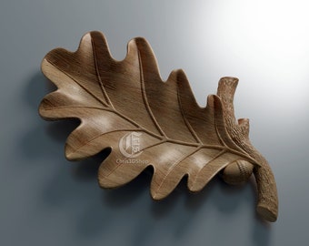 May include: A wooden oak leaf and acorn sculpture. The leaf is detailed with veins and the acorn is attached to a small branch.