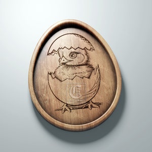 May include: A wooden egg-shaped ornament featuring a detailed carving of a baby chick hatching from the egg.