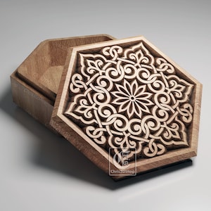 May include: A wooden hexagonal box with an intricate carved design on the lid. The lid is open, revealing the empty interior of the box.