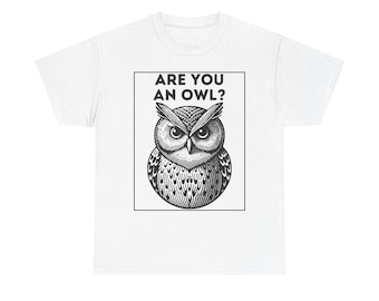 May include: White t-shirt featuring a black and white illustration of an owl within a rectangular frame. The text "ARE YOU AN OWL?" is printed above the owl. The owl has detailed feather patterns and large eyes.