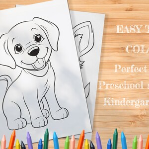 May include: A black and white line drawing of a happy puppy sitting with its tongue sticking out. The image is on a white sheet of paper with the text "EASY TO COLOR" and "Perfect for Preschool and Kindergarten" written in white on a wood background.