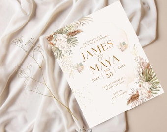 以下が含まれることがあります： フローラルデザインのウェディング招待状。「James & Maya」の名前、日付「2025年7月20日」、RSVP情報が記載されています。デザインには、白、茶色、緑の色合いの水彩画の花と乾燥した葉が含まれています。