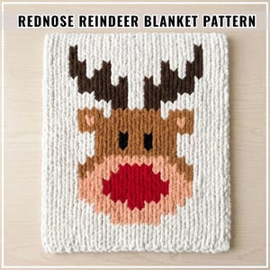 May include: A white crocheted blanket featuring a pixelated reindeer face with dark brown antlers, black eyes, and a large red nose. The text REDNOSE REINDEER BLANKET PATTERN is displayed at the top of the image in a clear, bold, black font.