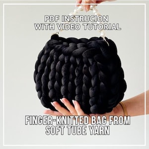 May include: A black finger-knitted bag made from soft tube yarn. The bag has a rounded shape and a pearl handle. Text on the image reads "PDF instruction with video tutorial" and "Finger-knitted bag from soft tube yarn."