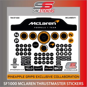 May include: A sheet of SF1000 McLaren Thrustmaster stickers. The stickers feature the McLaren Formula 1 team logo, various dials, buttons, and text labels in black, orange, and white. The text "PINEAPPLE GRIPS EXCLUSIVE COLLABORATION" is also visible.