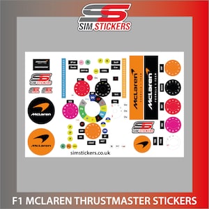 May include: A set of McLaren Formula 1 Team themed stickers for a Thrustmaster racing wheel. The stickers feature the McLaren logo, the team's colors, and the words "Formula 1 Team". The stickers are designed to be placed on the buttons and dials of the racing wheel.