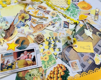 May include: A collection of yellow and white paper ephemera, including illustrations of birds, flowers, and a rabbit. There are also several pieces of patterned paper, including a yellow polka dot pattern and a yellow floral pattern. The text "That's Your" is visible on one of the pieces of paper.