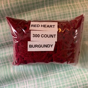 May include: A bag of burgundy Red Heart embroidery floss, 300 count.