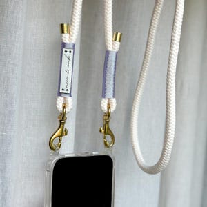 Chaîne pour téléphone portable crème « Licorne » avec mousqueton doré et étui pour téléphone portable transparent