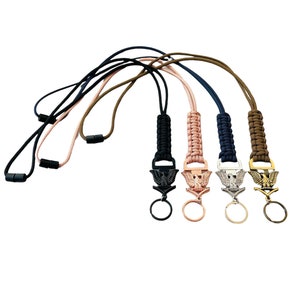 May include: Five paracord lanyards with eagle-shaped metal clips and key rings. The lanyards are in black, brown, pink, blue, and green.