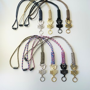 May include: Set of six paracord lanyards with different colored cords and metal eagle charms. The charms have a silver, gold, black, and gold finish.