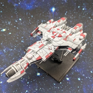 May include: A detailed model of a spaceship, primarily white with red accents. The spacecraft has multiple engines and a central circular structure. It is mounted on a black base against a starry background, suggesting a space theme.