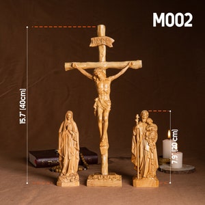 May include: A wooden crucifix with a carved figure of Jesus Christ, a wooden statue of the Virgin Mary, and a wooden statue of Saint Joseph with the baby Jesus. The crucifix is 15.7 inches tall and the statues are 7.9 inches tall.