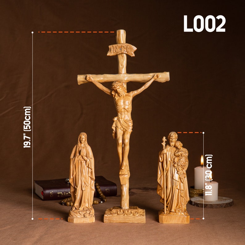 May include: A wooden crucifix with a carved figure of Jesus Christ, a wooden statue of the Virgin Mary, and a wooden statue of Saint Joseph with the baby Jesus. The crucifix is 19.7 inches tall and the statues are 11.8 inches tall.